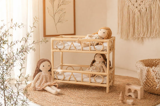 Handcrafted rattan doll bunk bed in a boho nursery with neutral decor and wooden toys.