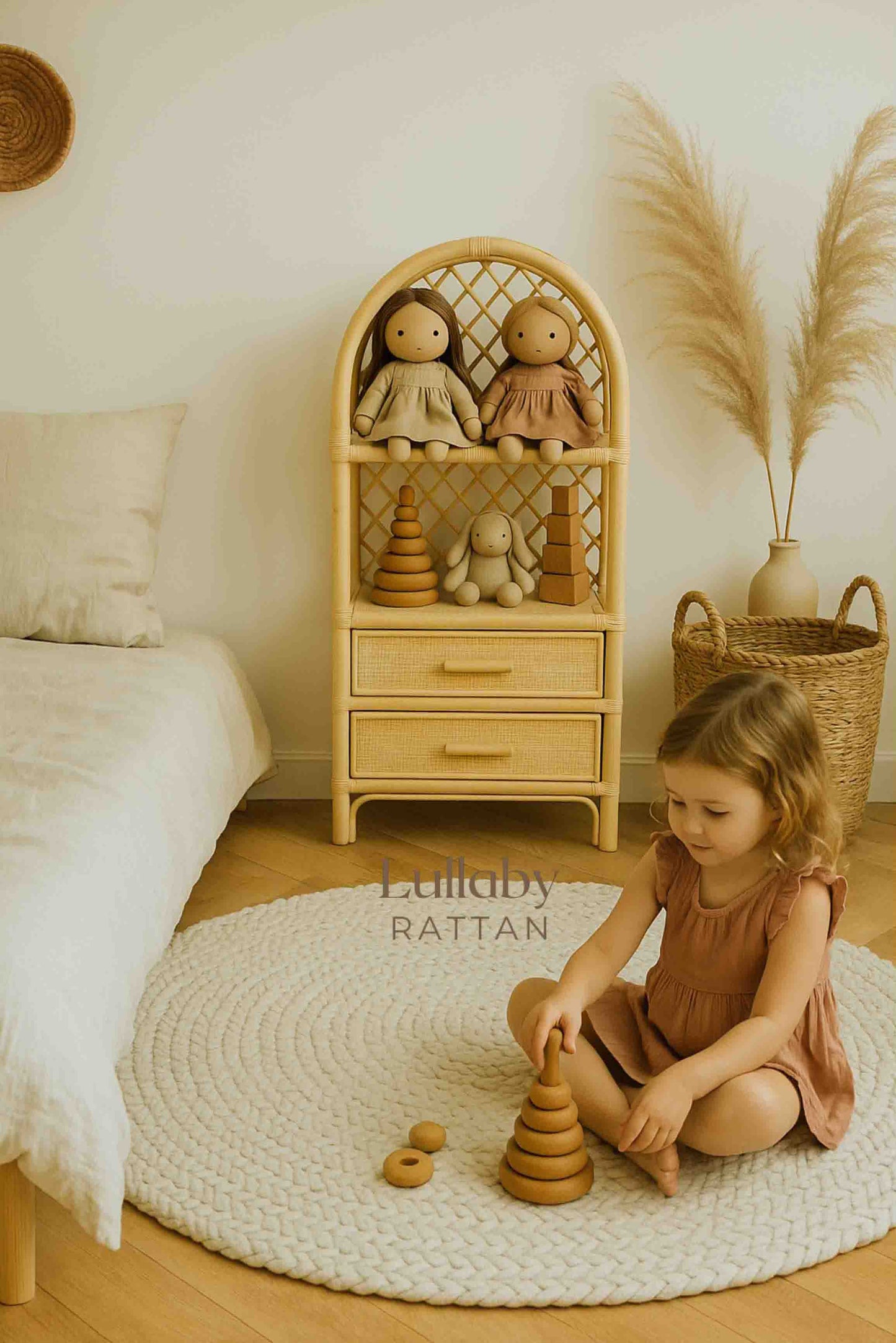 Rattan toy and book storage shelf styled in a child’s playroom with dolls and wooden toys.