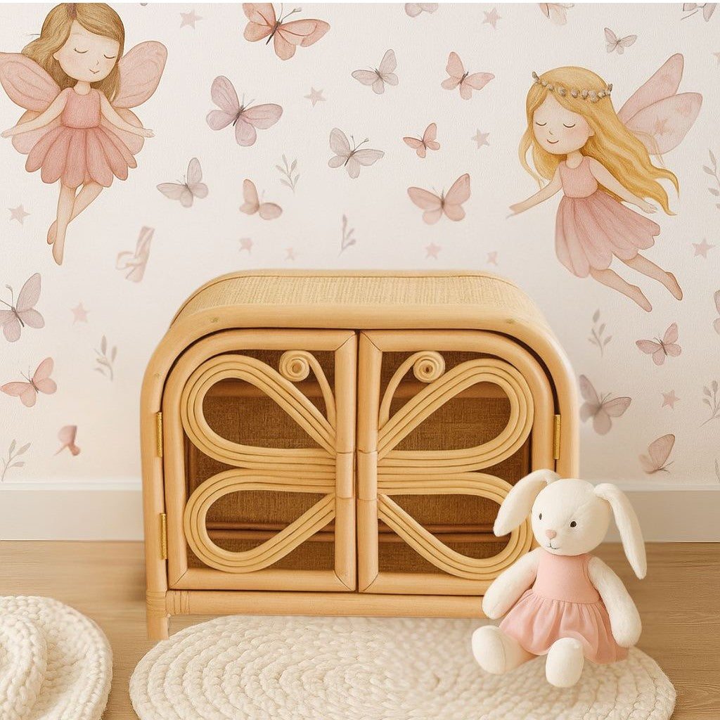 Wooden toy box with fairy-themed wallpaper and a plush rabbit toy on a wooden floor. There is a butterfly theme wardrobe where a little girl can hang her doll clothes and leave her accessories.