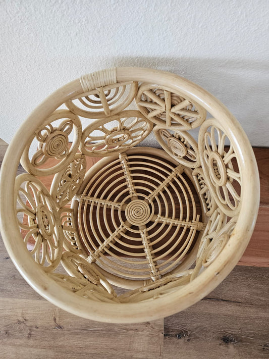 Decorative woven basket with intricate patterns on a wooden surface.