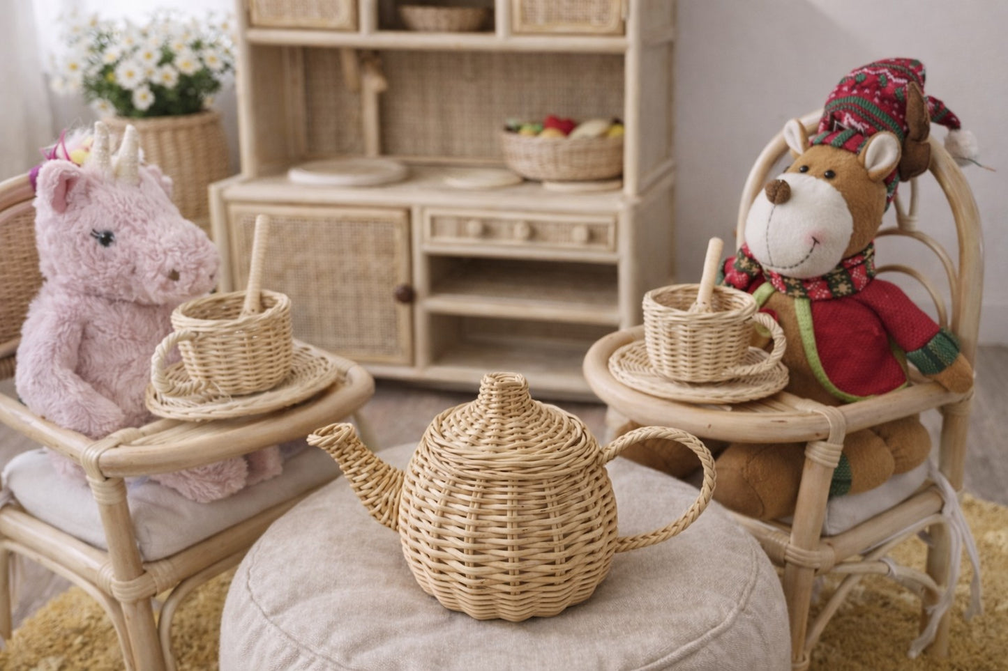 Children's playroom with wicker furniture, toys, and a teapot.