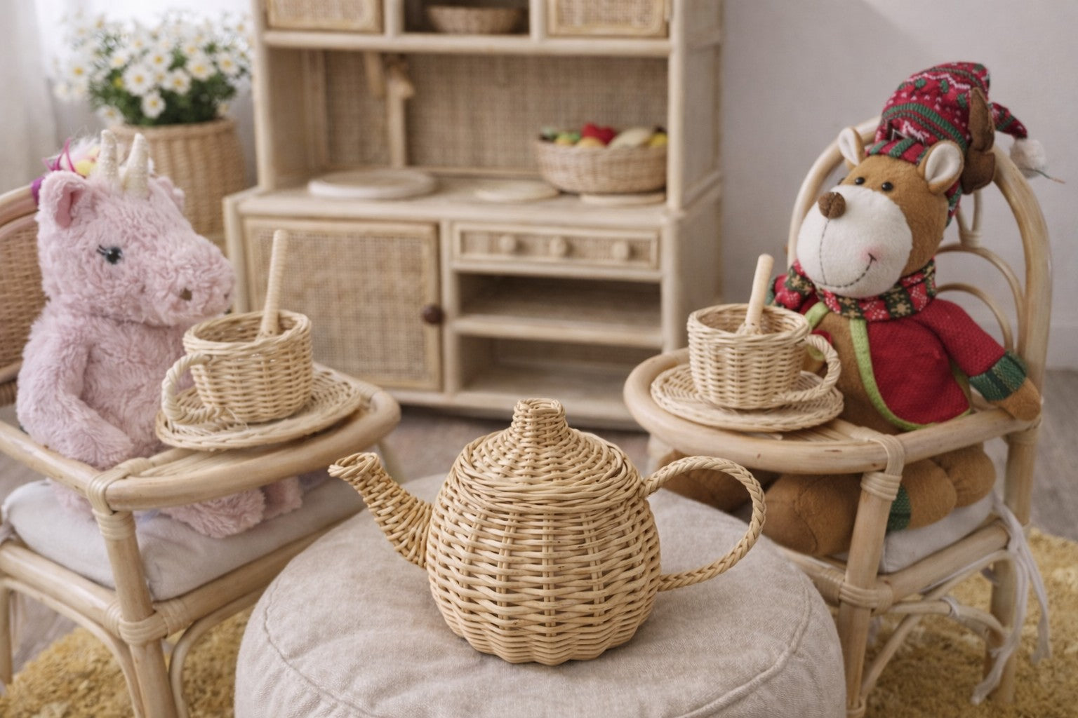 Children's playroom with wicker furniture, toys, and a teapot.