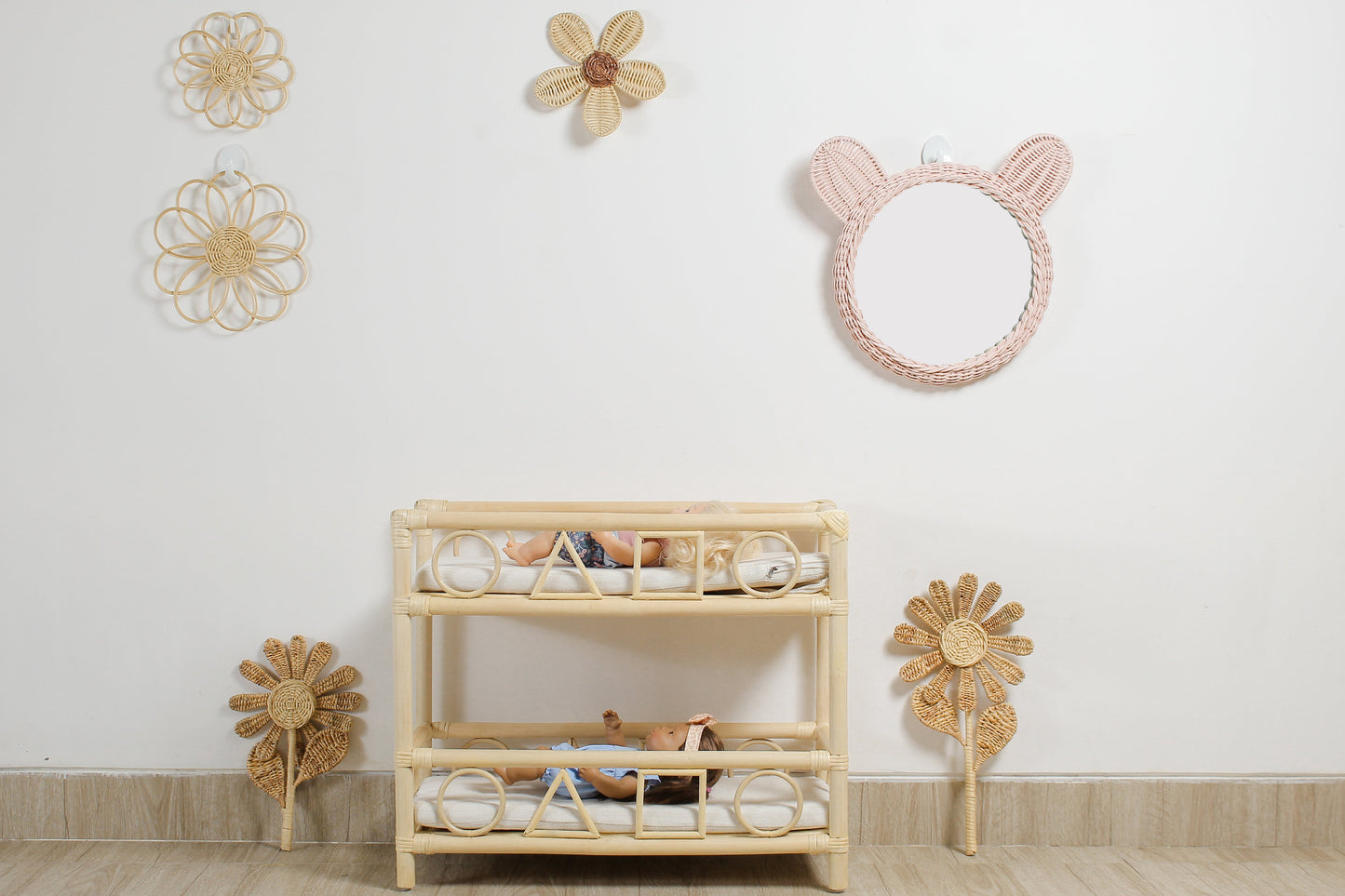 Boho flower wall decor made from rattan displayed in a girls playroom above doll furniture