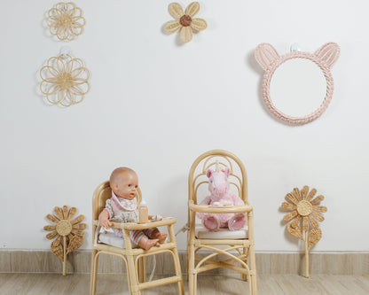 Floral rattan nursery wall art styled in a girls room with wooden toys and boho decor