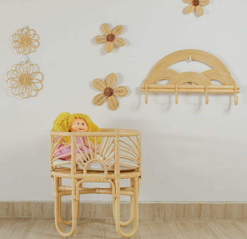 Small rattan flower wall art set styled in a girls playroom with doll furniture and toys