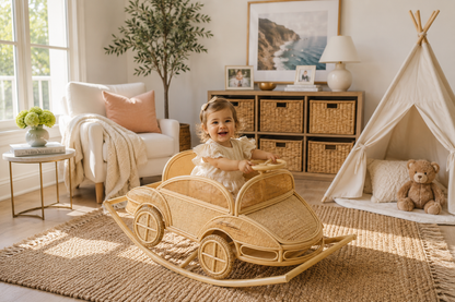 Child playing with a wooden toy car in a cozy room with a teepee and teddy bear.