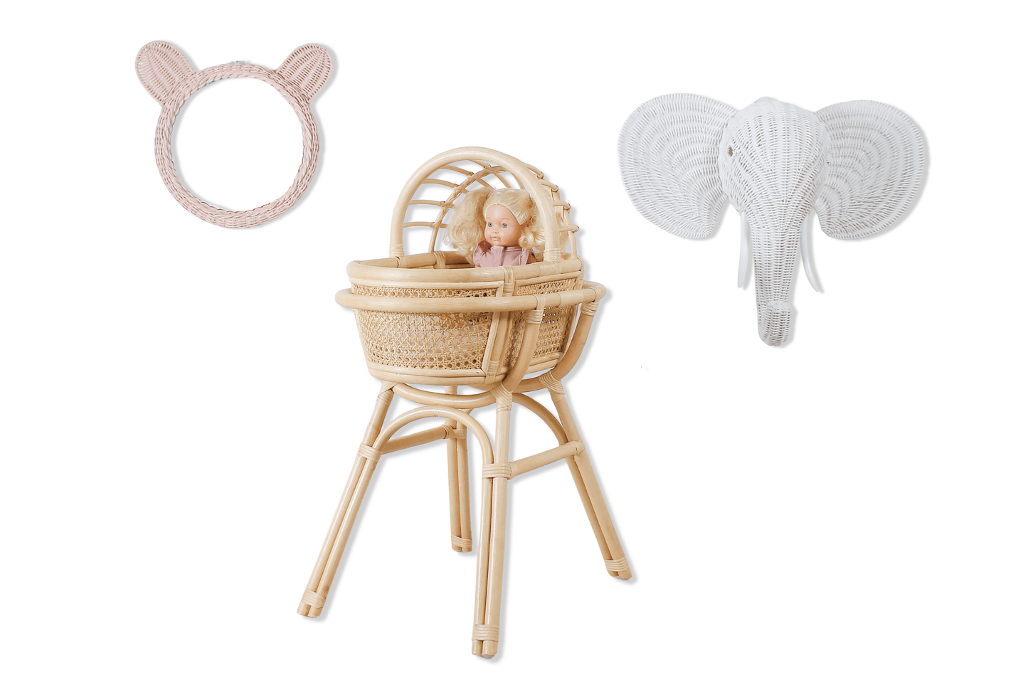 A doll in a rattan made doll play bassinet with an elephant head for decoration and teddy bear wall mirror