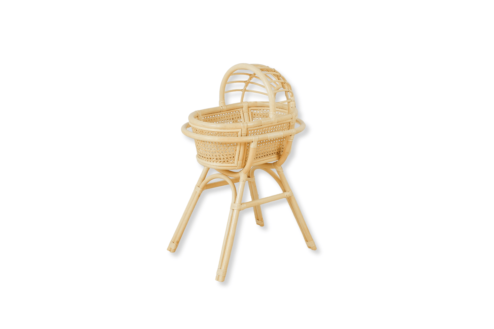 A small, beige rattan bassinet with a woven pattern and a gracefully arched canopy, designed for doll or teddy bear resting.