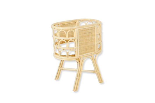 A handcrafted beige rattan bassinet with an arched design, designed for doll and teddy bear storage. Crib for plush toys. 