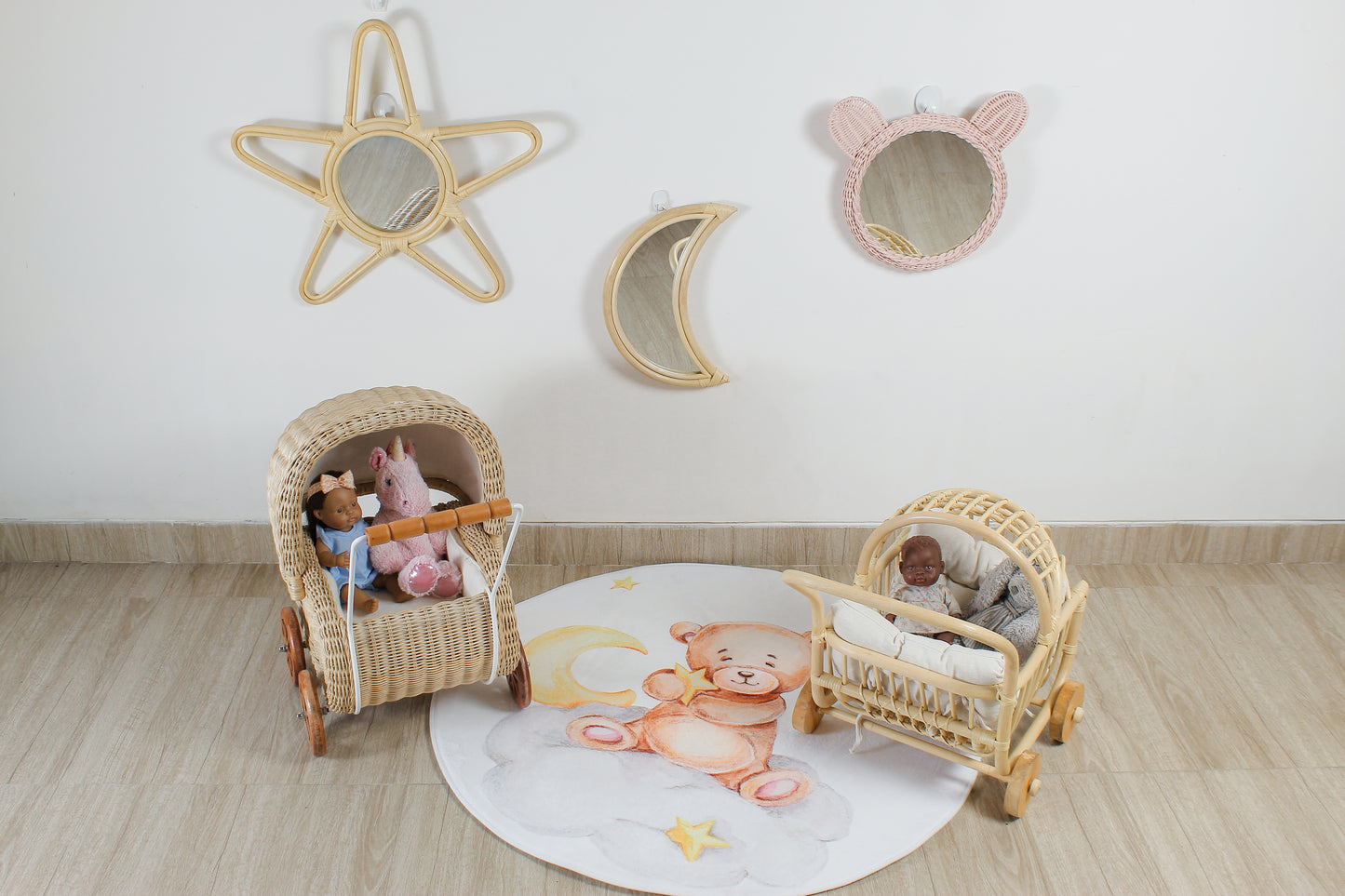 Children's room with wicker furniture, toys, and decorative wall art on a light wooden floor.
