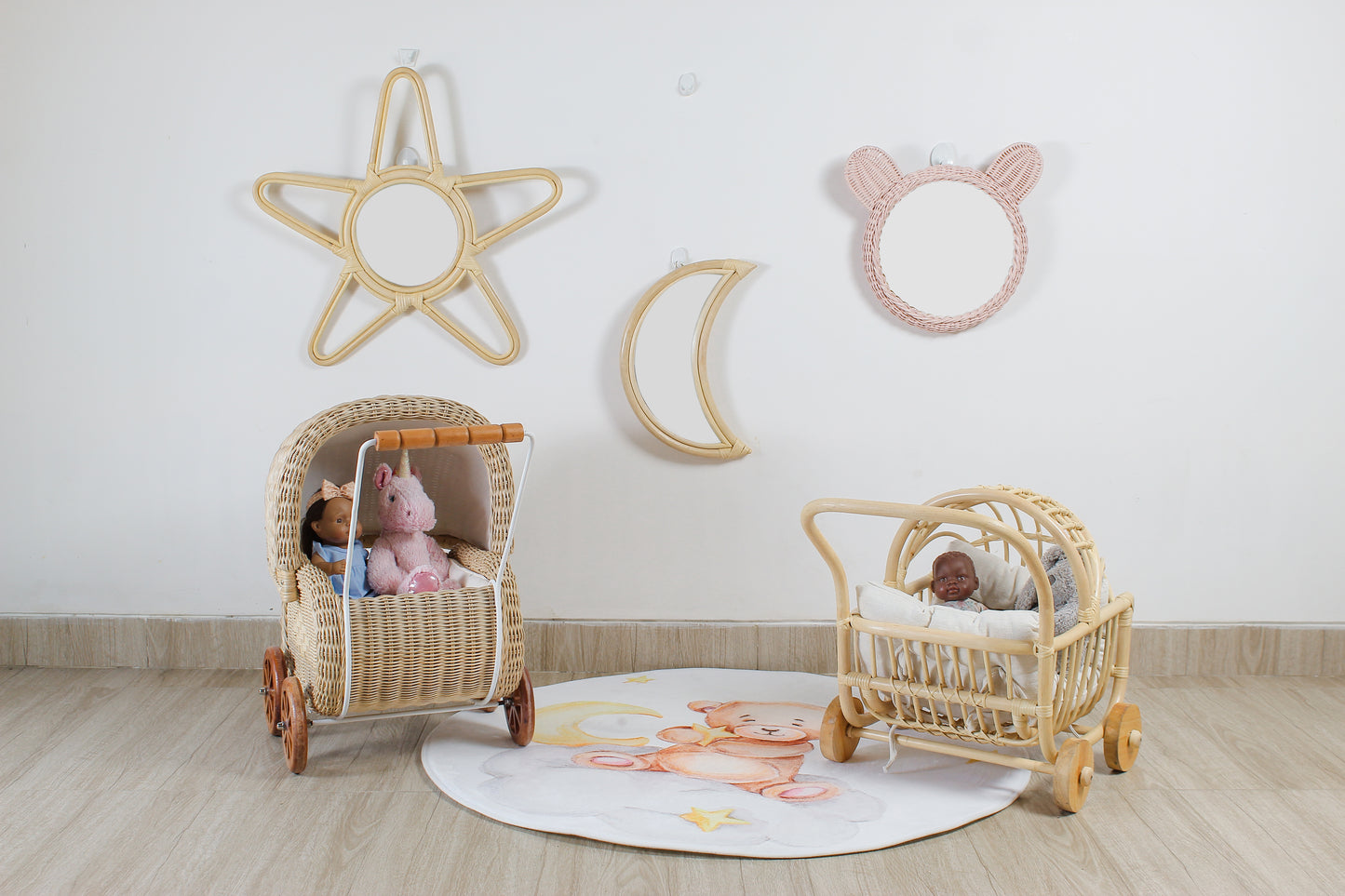 Children's room with decorative wall art and baby buggies on a wooden floor.
