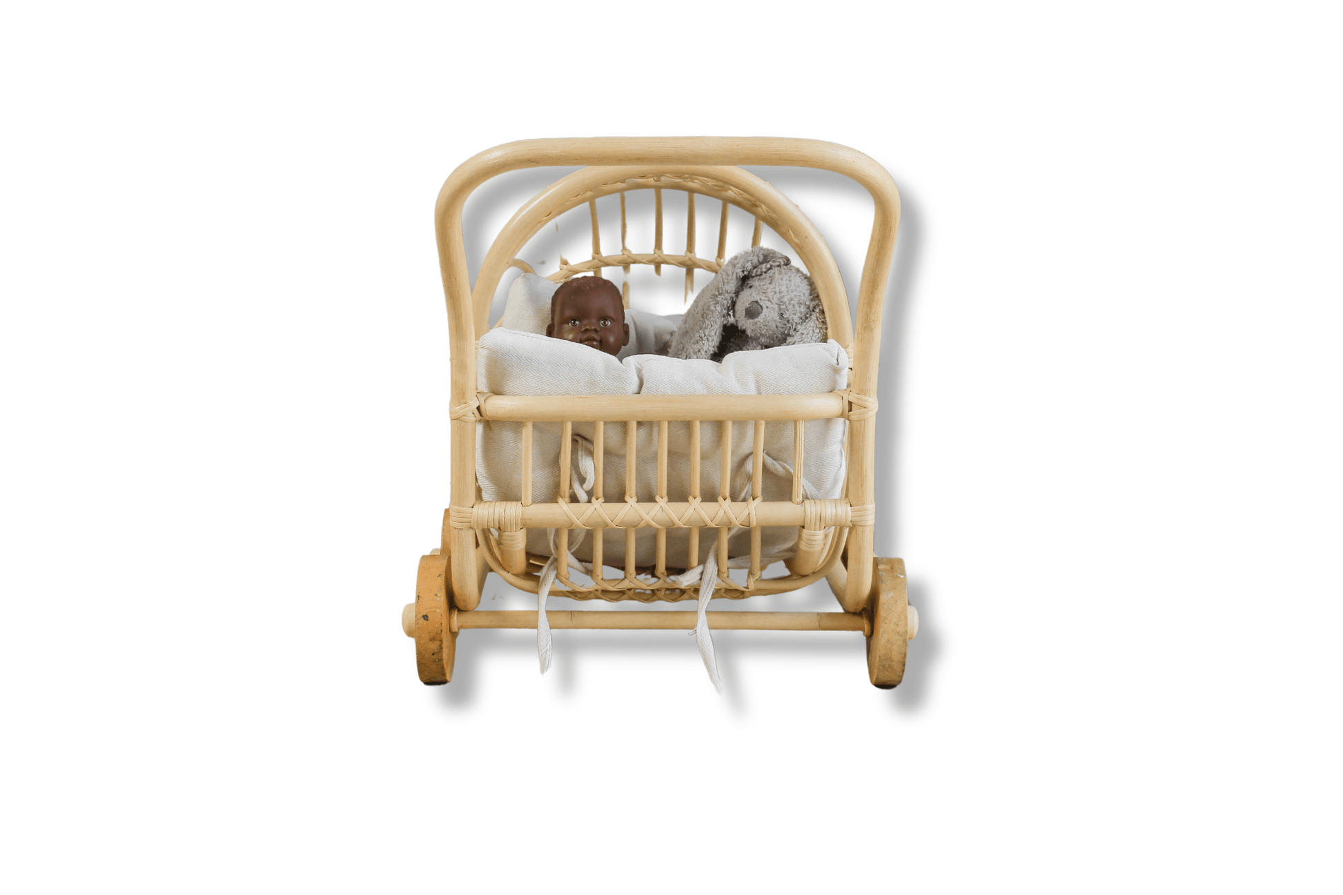 A doll buggy with a black doll and bunny rabbit toy