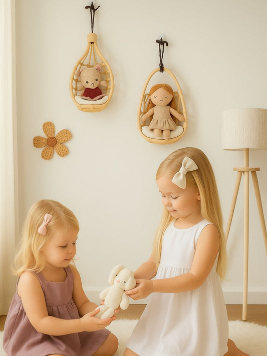 Two young girls playing with stuffed toys in a room with decorative elements. Eco-friendly rattan doll chair wall hanger, a perfect birthday or Christmas gift for young girls ages 2–6.