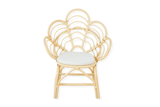 A decorative rattan chair with a petal pattern design, featuring a natural color finish and a white seat cushion.