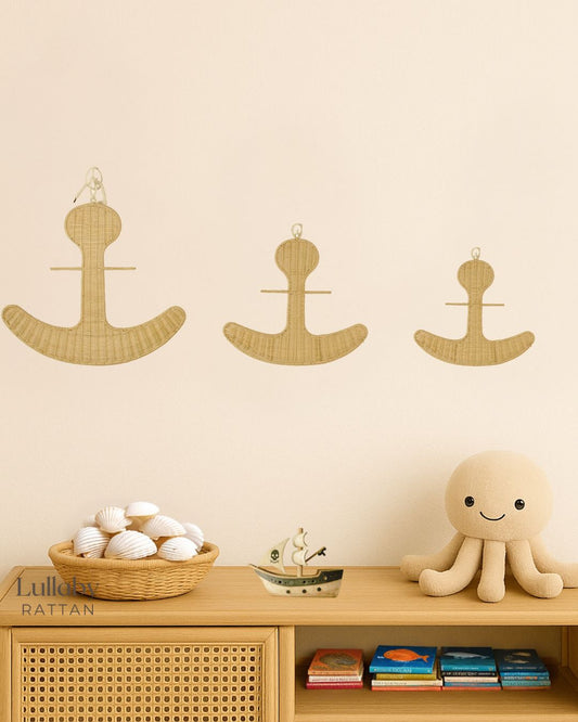 Anchors on a wall with a jellyfish, pirate ship, basket of shells and kids themed ocean books telling of different types of fish