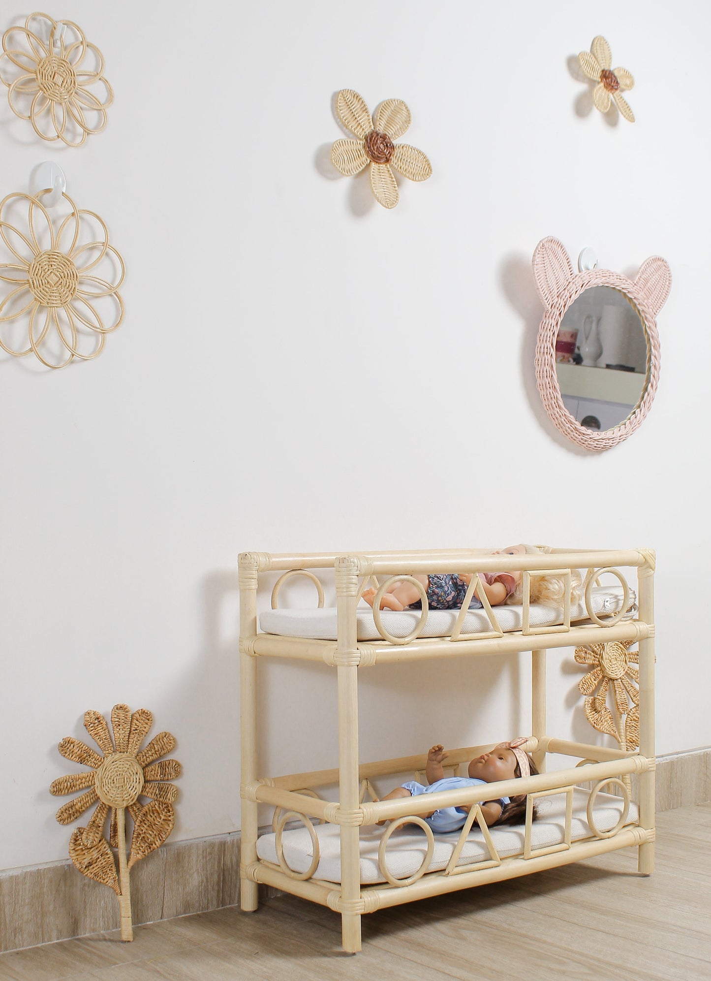 Children's room with a wooden crib, toys, and decorative wall mirrors.