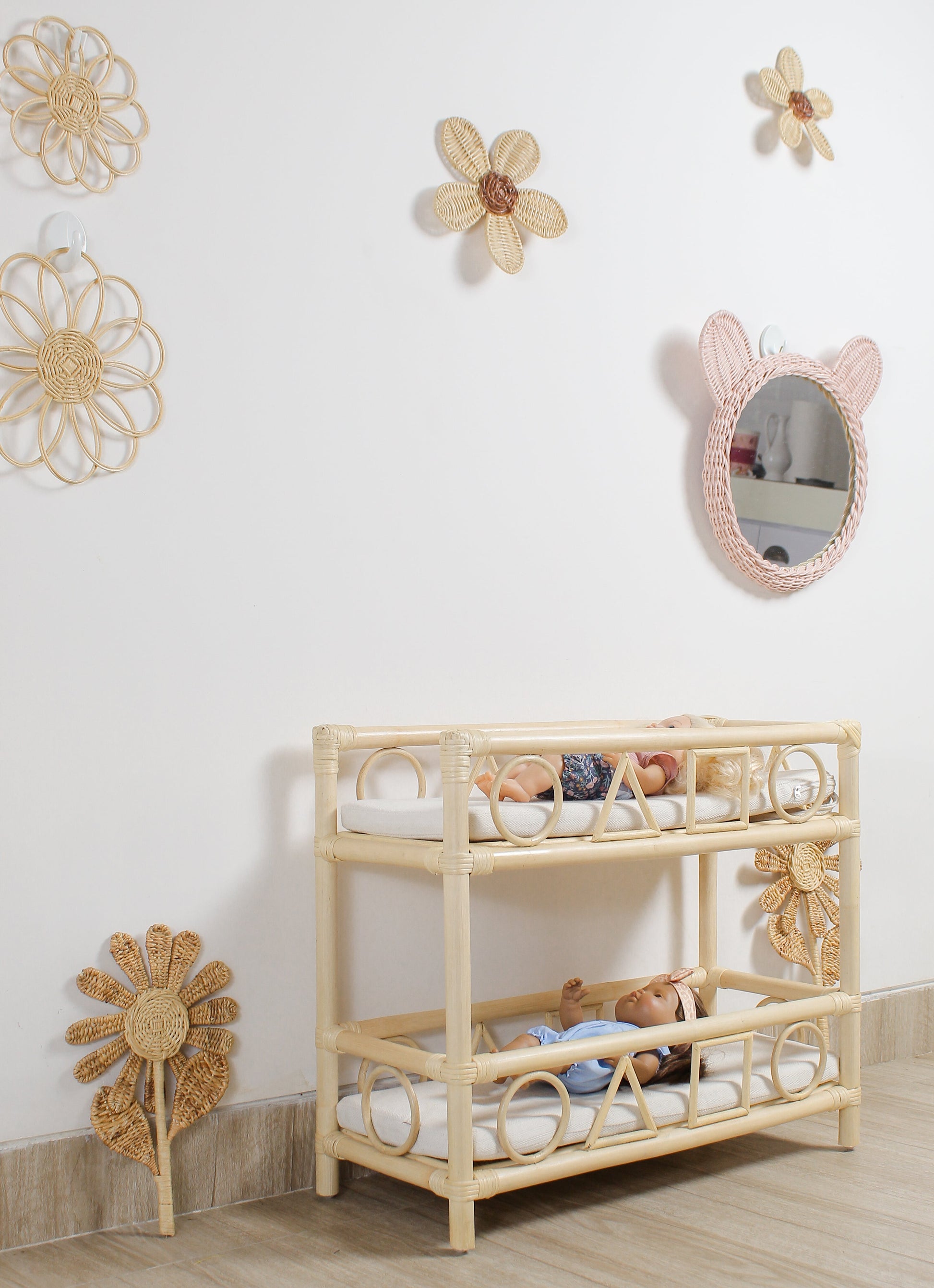 Children's room with a wooden crib, toys, and decorative wall mirrors.
