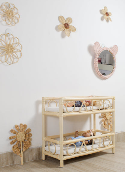 Children's room with a wooden crib, toys, and decorative wall mirrors.