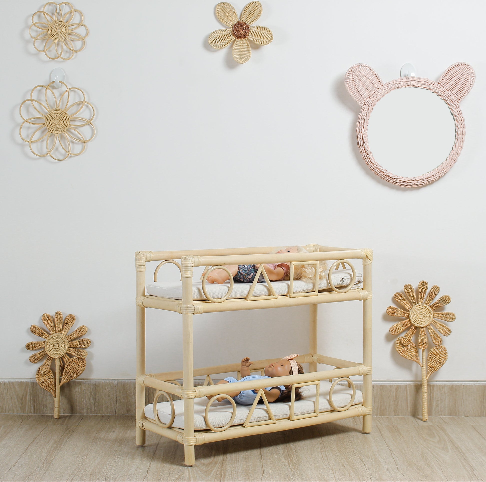 Rattan crib with toys in a room decorated with wicker wall hangings.