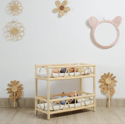Rattan crib with toys in a room decorated with wicker wall hangings.