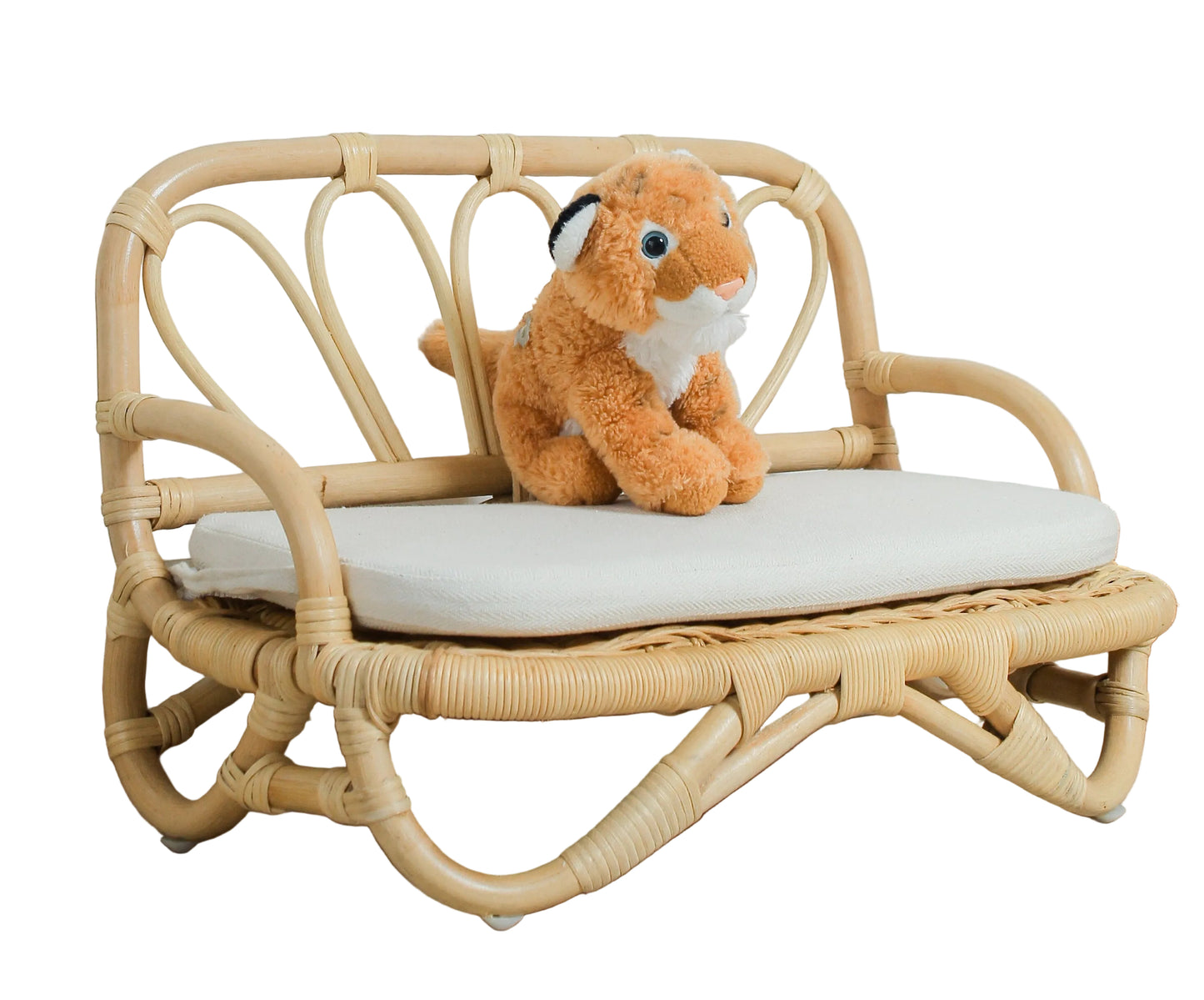Small wooden bench with a plush toy on a light wooden floor against a white wall.