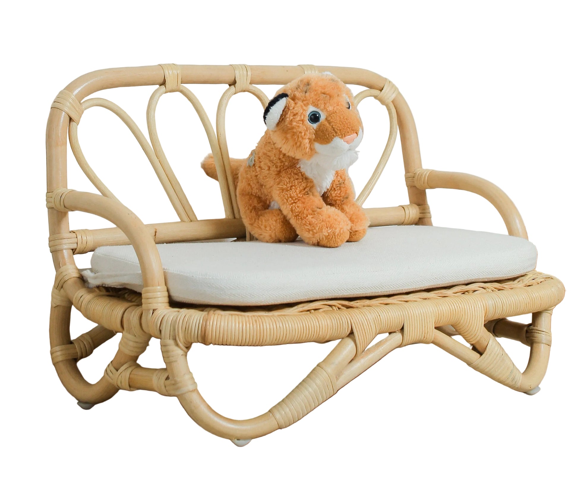 Small wooden bench with a plush toy on a light wooden floor against a white wall.