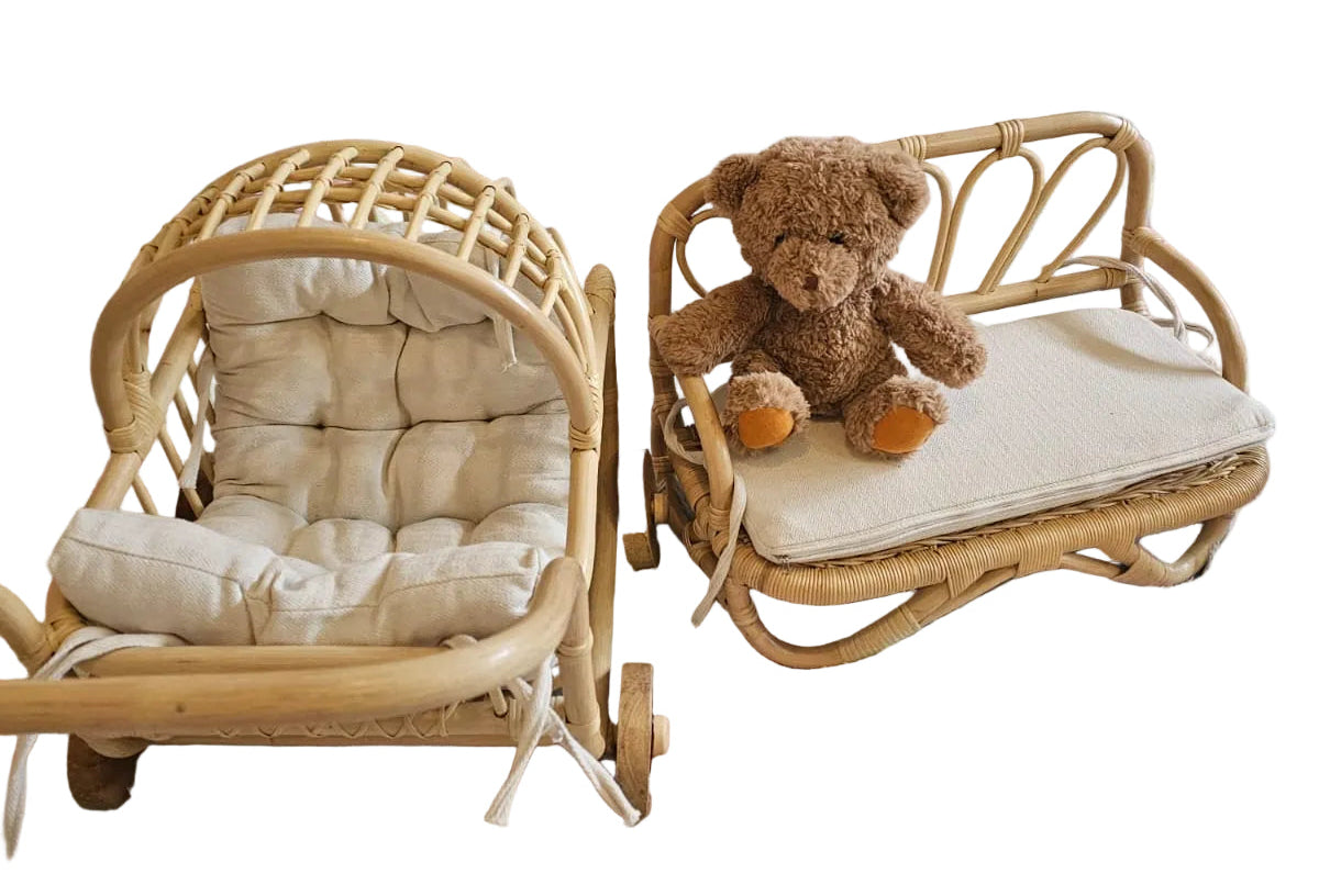 Children's room with wicker chairs and a teddy bear on a colorful rug.