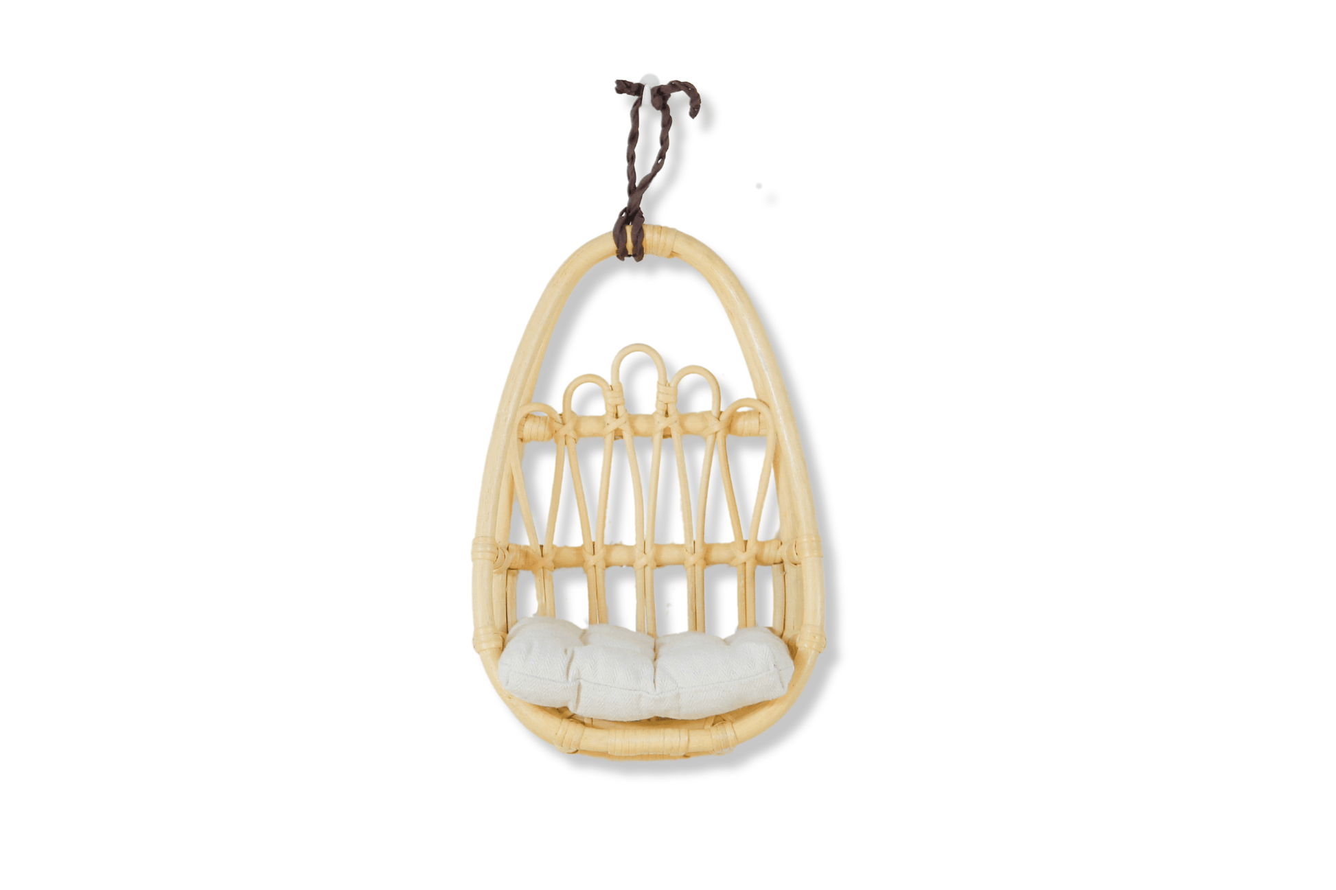 Beautiful rattan wall decor piece styled in a toddler girl’s boho bedroom with light earthy tones.