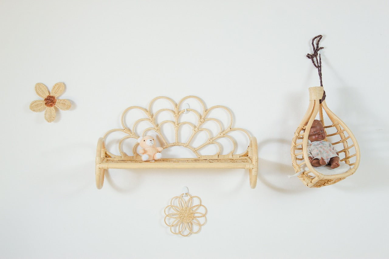 Decorative items including a woven basket, shell, and small figurines on a white background. Natural rattan wall decor piece styled for toddler girls’ boho bedrooms, perfect for birthdays or Christmas gifts.
